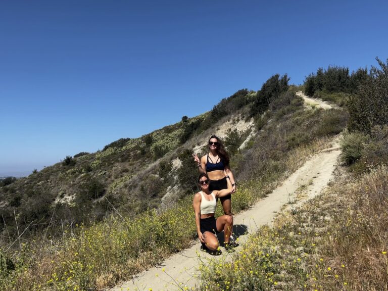 Two Woman Are Hiking up a Hill